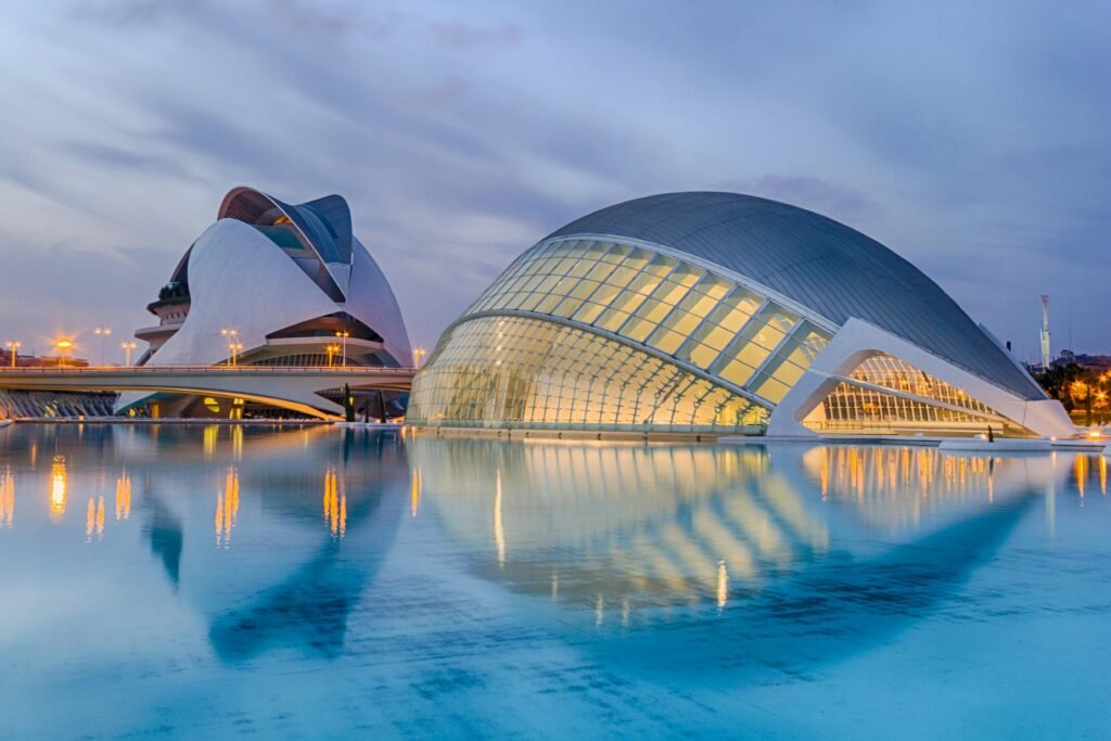 A breathtaking view of Valencia's City of Arts and Sciences reflected in serene waters at twilight.
